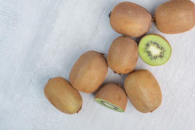 Ripe kiwi fruits on stone background. High quality photo