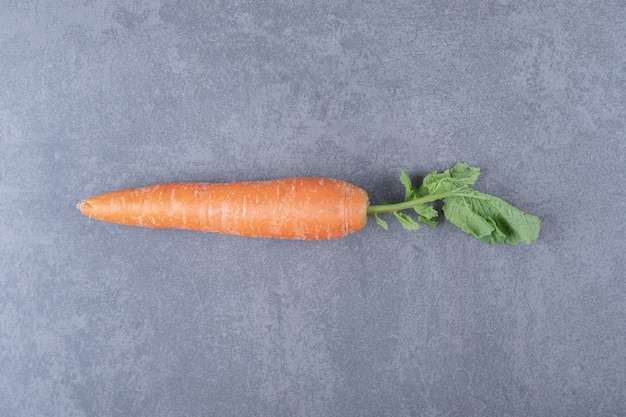 Free photo ripe organic carrots , on the marble surface.