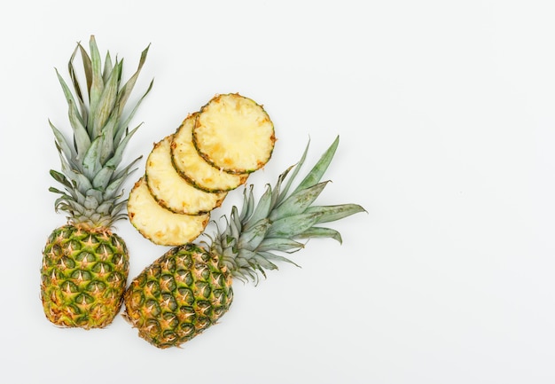 Ripe pineapple hala and slices flat lay on a white