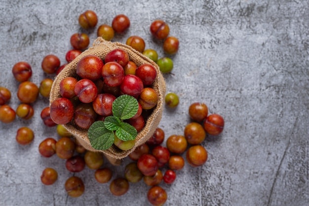 Ripe plums on the dark surface.