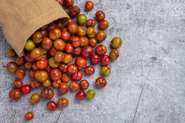 Ripe plums on the dark surface.