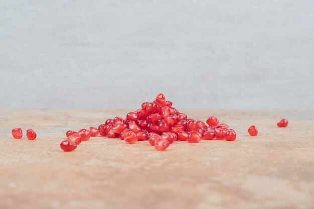 Ripe pomegranate seeds on marble background. 