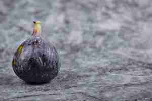 Free photo ripe purple fig on a marble table.