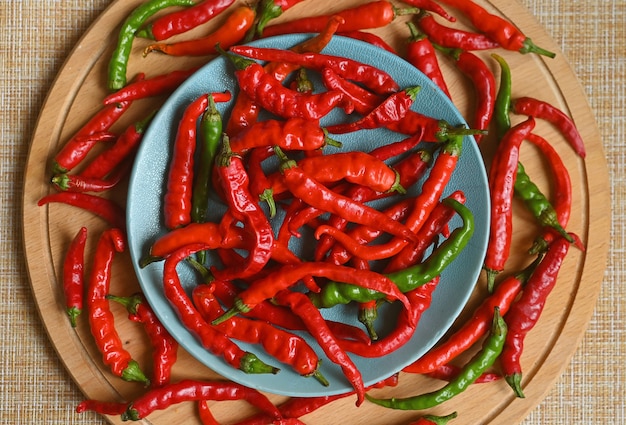 Ripe red chili peppers on a wooden board harvest from the garden spices and food additives