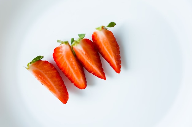 Ripe red strawberries on a plate.