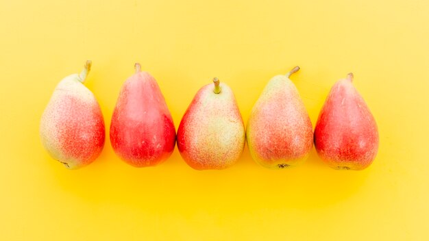 Ripe red whole pears in row