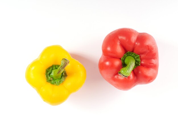 Ripe red and yellow bell peppers. Isolated on white surface. Sweet pepper isolated on a white surface.