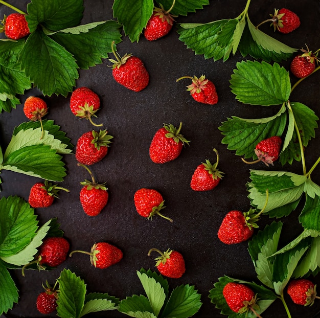 Ripe strawberries and leaves. Top view