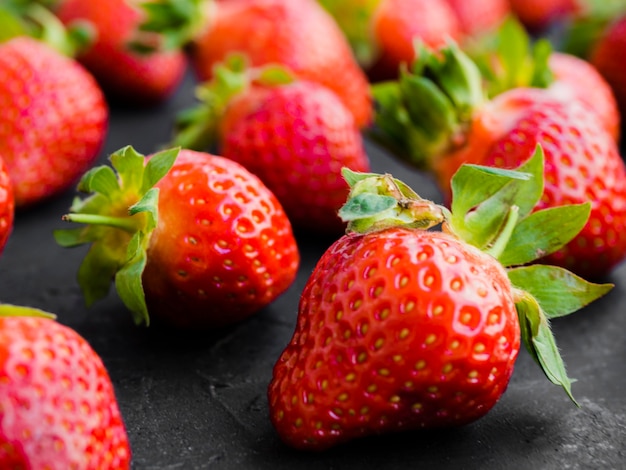 Ripe strawberry on black surface