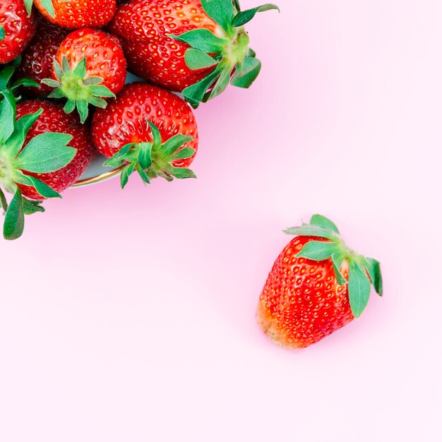 Ripe strawberry on light surface