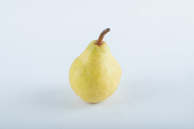 Ripe yellow pear on white.