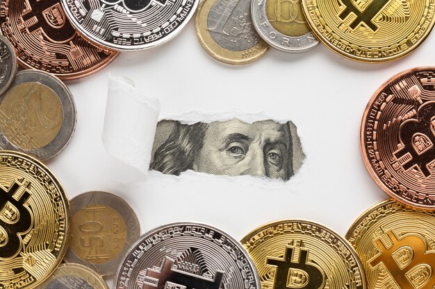 Ripped paper revealing banknote with bitcoin