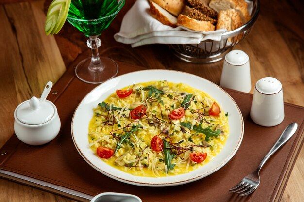 risotto with tomatoes mushroom cheese arugula tarhun lemonade salt pepper and bread on table
