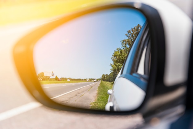 Road reflected on side mirror
