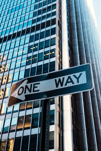 Road sign One way on building background