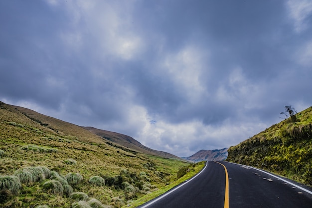 a road with foggy hills