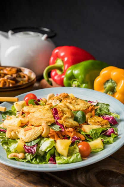 Roast chicken fillet and vegetables salad on ceramic plate