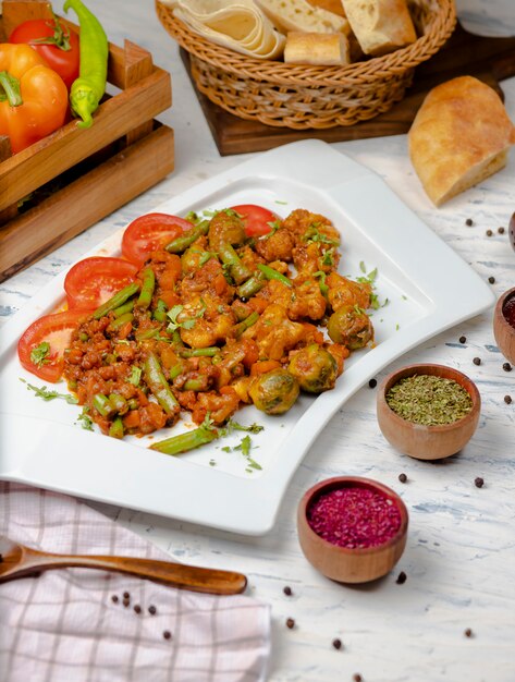 Roasted cauliflower with sprouts, beans and served with tomato sauce and herbs