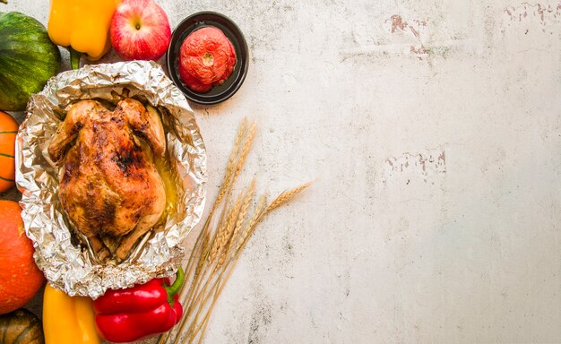 Roasted chicken on foil with vegetables