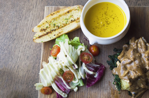 Roasted chicken served with salad and garlic bread