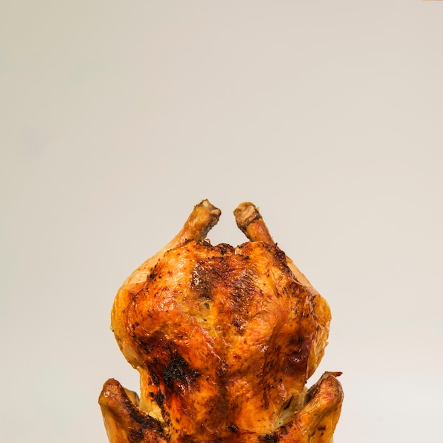 Roasted chicken standing on white background