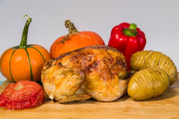 Roasted chicken with vegetables on table