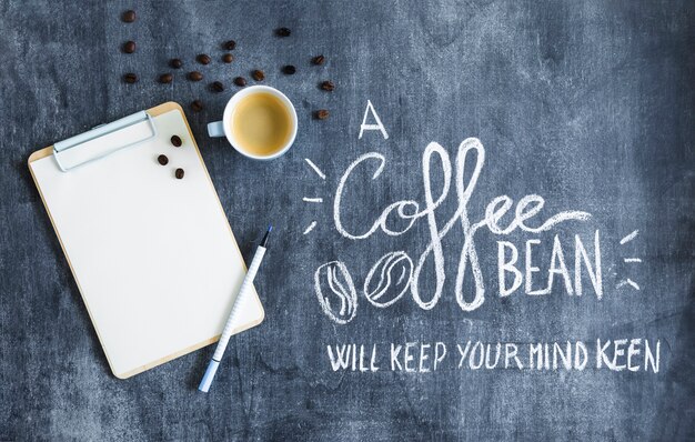 Roasted coffee beans and coffee on the clipboard with text on the chalkboard