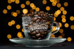 Free photo roasted coffee beans in a glass cup against yellow bokeh lights