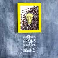 Free photo roasted coffee beans and paper cutout light bulb frame with text on chalkboard