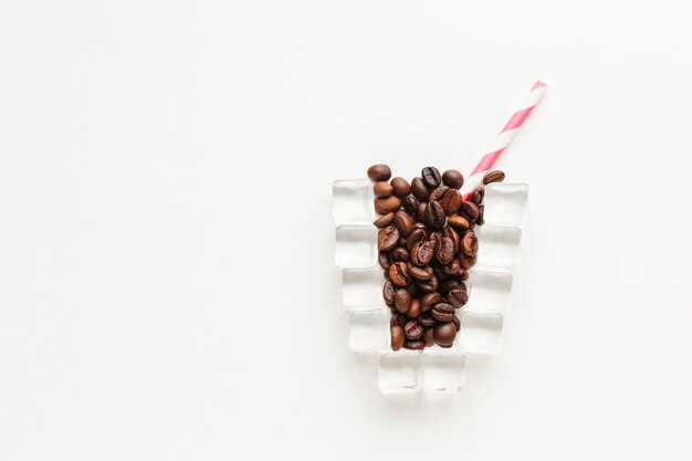 Roasted coffee beans and straw with copy space