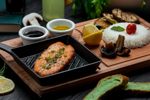 Roasted salmon in an ironic pan served with teriyaki sauce