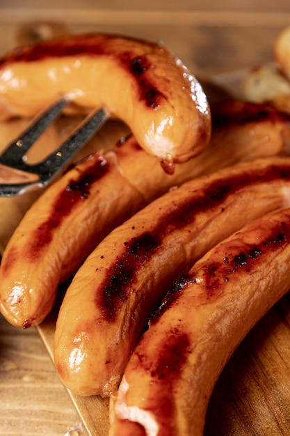 Roasted sausages with grill fork on a table