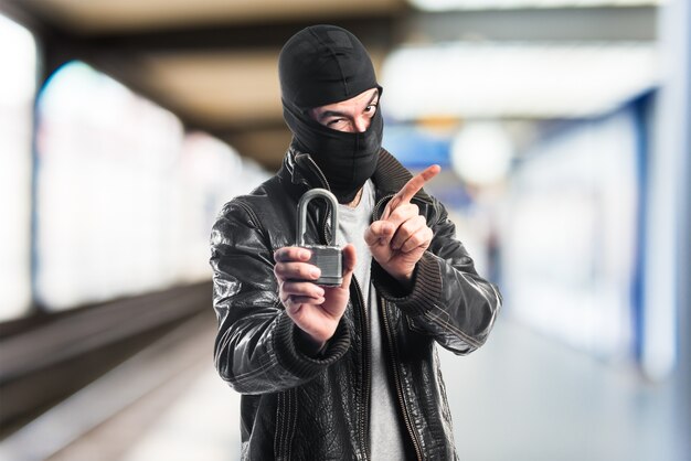 Robber holding vintage padlock