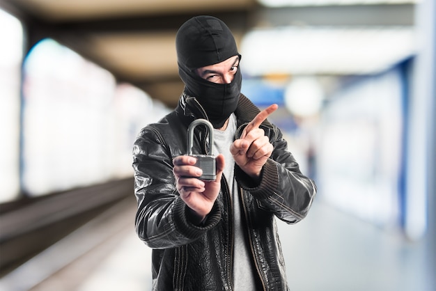 Robber holding vintage padlock