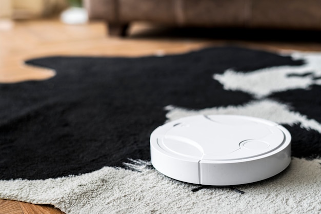 Robotic vacuum cleaner on an animal print rug