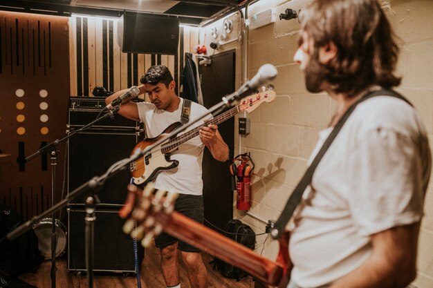 Rock band guitarist performing repetition in recording studio