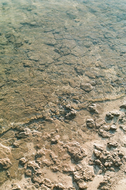 Rocks on a beach covered by the crystal clear water