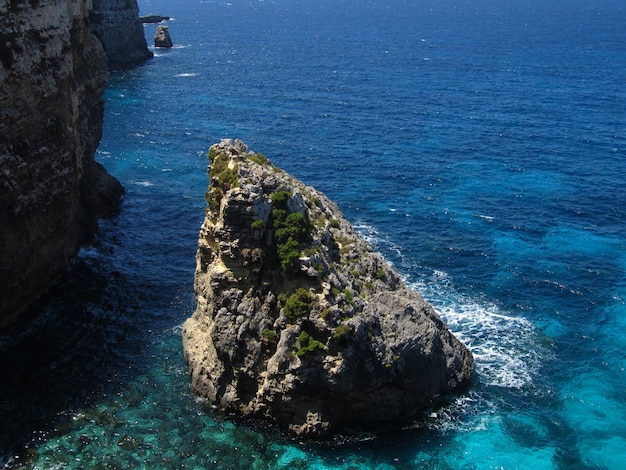 Rocks of the coastline of Comino in Malta surrounded by water