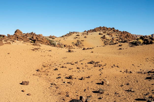 澄んだ青い空と岩が多い砂漠