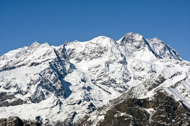 Rocky mountain covered in the sea under the sunlight and a blue sky at daytime