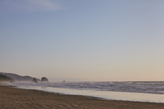 Rocky shoreline of the Pacific Ocean at Cannon Beach, Oregon, USA