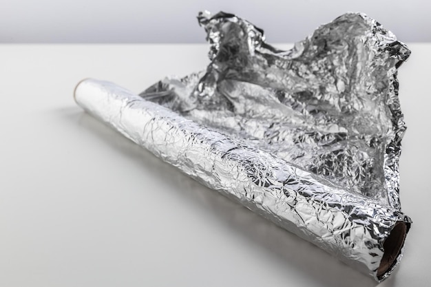 Roll of aluminum foil isolated on white background