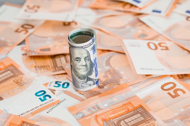 roll of money on grey and banknote table .