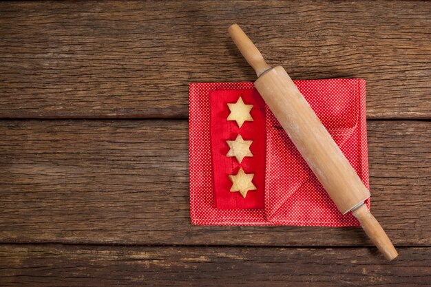 Roll with star-shaped cookies on a wooden table