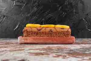 Free photo rollcake with lemon on a wooden board.