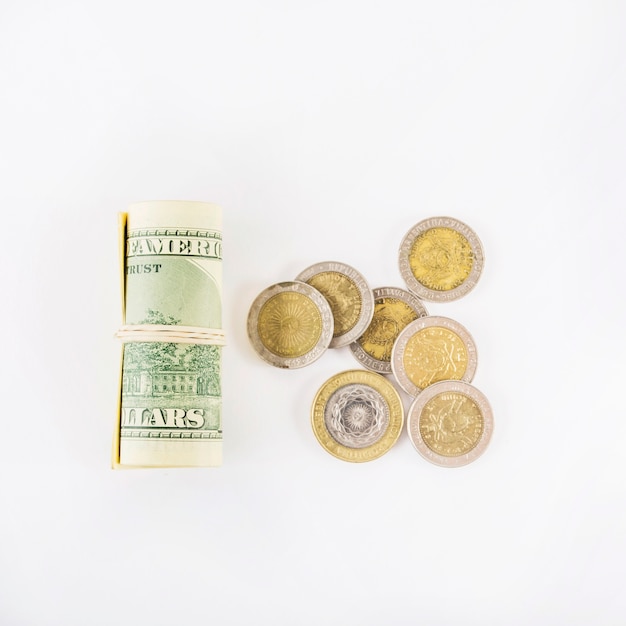 Rolled dollars and coins on table