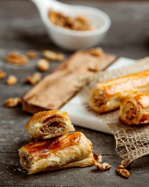 Rolled puff pastry filled with mashed walnut and sugar mix