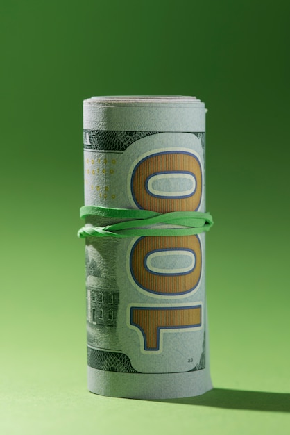 Rolled up banknotes isolated on green background