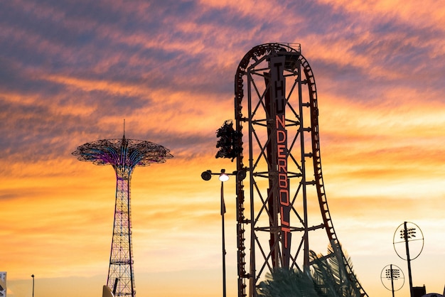 "Roller coaster with cloudy sky behind"