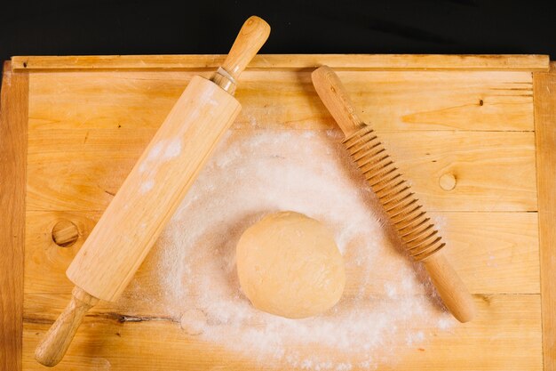 Rolling pins and dough on board